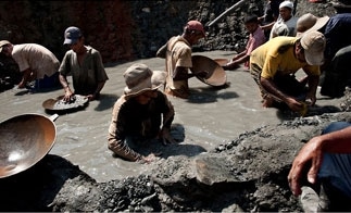 Miners pan for gold at an illicit pit in Antioquia, Colombia