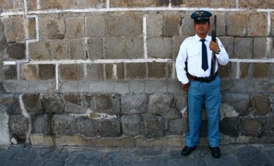 A private security guard stands watch in Guatemala City