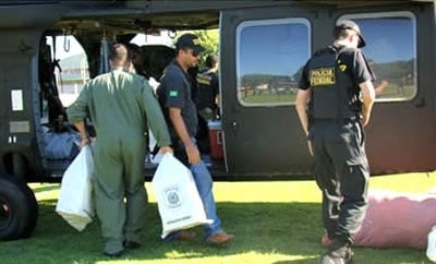 Brazilian officials unload a seized drug plane from Bolivia