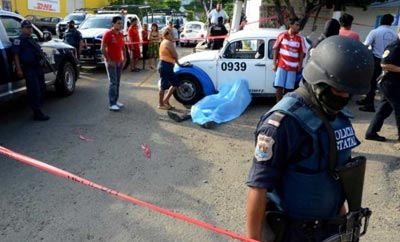 Police inspect the scene of a murder in Acapulco, Mexico