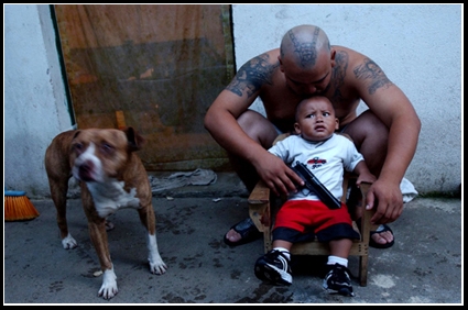 Guatemalan Mara plays with his son