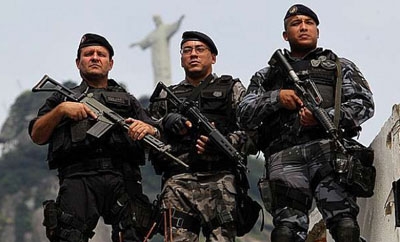 Brazilian military police stand below Cristo Redentor
