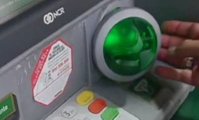 A "skimmer" installed at an ATM
