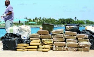 A Bahamas anti-drug officer with seized drugs
