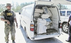 A Bahamas anti-drug officer with seized drugs