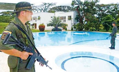 Colombian soldiers guard property seized from the FARC