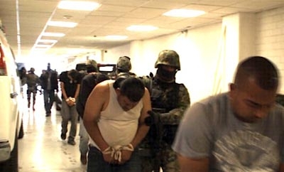 Police lead away alleged Sinaloa hitman alias '19'