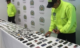 Colombia police with recovered cell phones