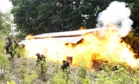 Colombian anti-narcotics police burn drug lab