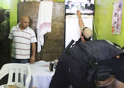Carlos Antonio Caballero, alias âCapilo,â stands as his cell is inspected