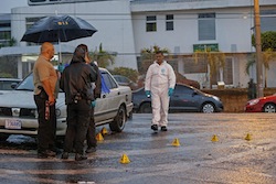 Costa Rica investigators at a murder scene