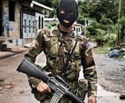 A Salvadoran soldier with his face covered