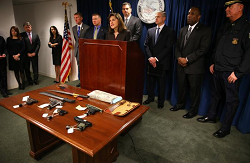 DOJ officials with weapons confiscated from the MS13