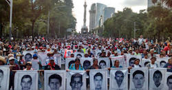 Protestors carry photos of the Iguala disappeared