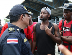 Costa Rican official talks with African migrants