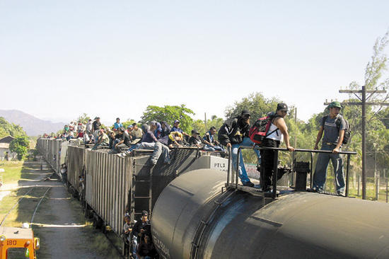 Migrants on a moving train in Mexico