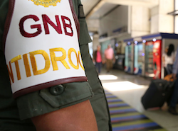 A Venezuelan National Guard member stands watch at an airport
