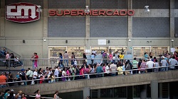 Venezuelans lining up in front of a supermarket
