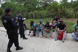 Federal police officers and migrants in Chiapas, Mexico.