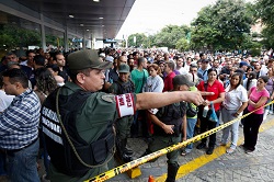 Venezuelans line up to buy food in a supermarket