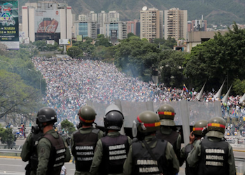 Venezuela security forces watch demonstrating protestors