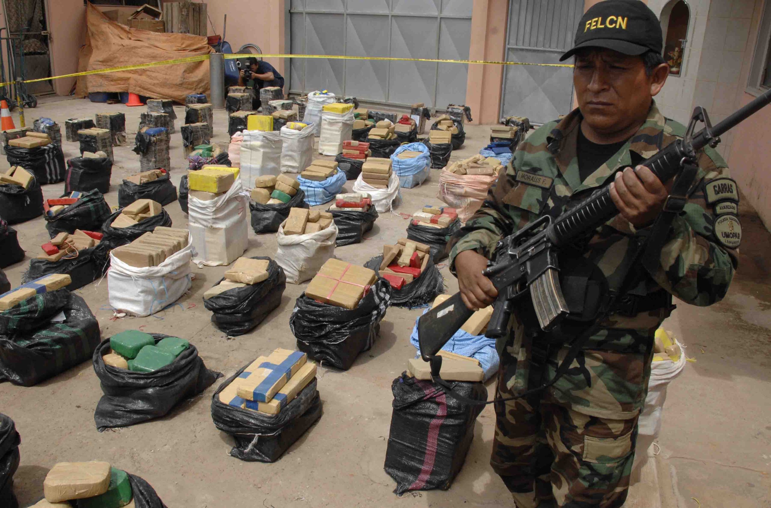 A police officer guards packages containing cocaine during a presentation to the media in Santa Cruz, Bolivia, Friday, March 19, 2010. (AP Photo)
