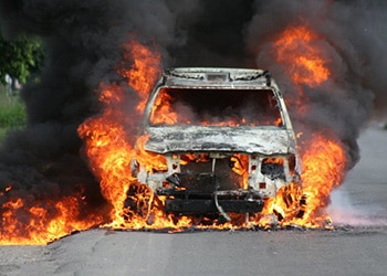 A police vehicle set on fire by prisoners