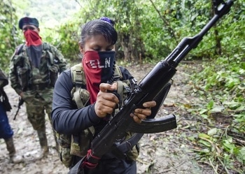 A child recruit of the ELN holding a gun