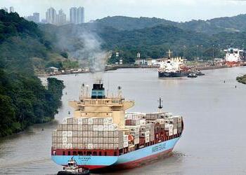 A cargo ship enters the Panama Canal on the Atlantic side near Colon