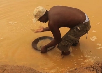 A man pans for gold at an illegal mining site in Guyana.
