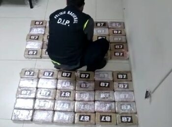 A security official stands over packets of cocaine seized at Panama City's international airport