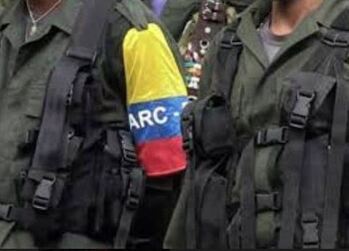 A former FARC soldier is seen wearing an armband of the now-demobilized guerrilla group