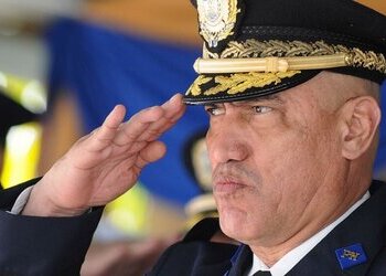 Honduras' former head of police, "El Tigre" Bonilla, saluting