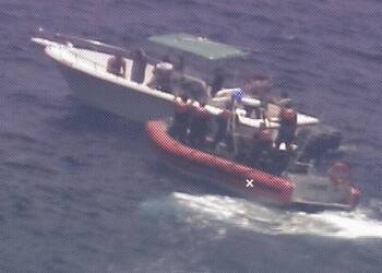 A Cuban Coast Guard vessel stops a speedboat carrying migrants
