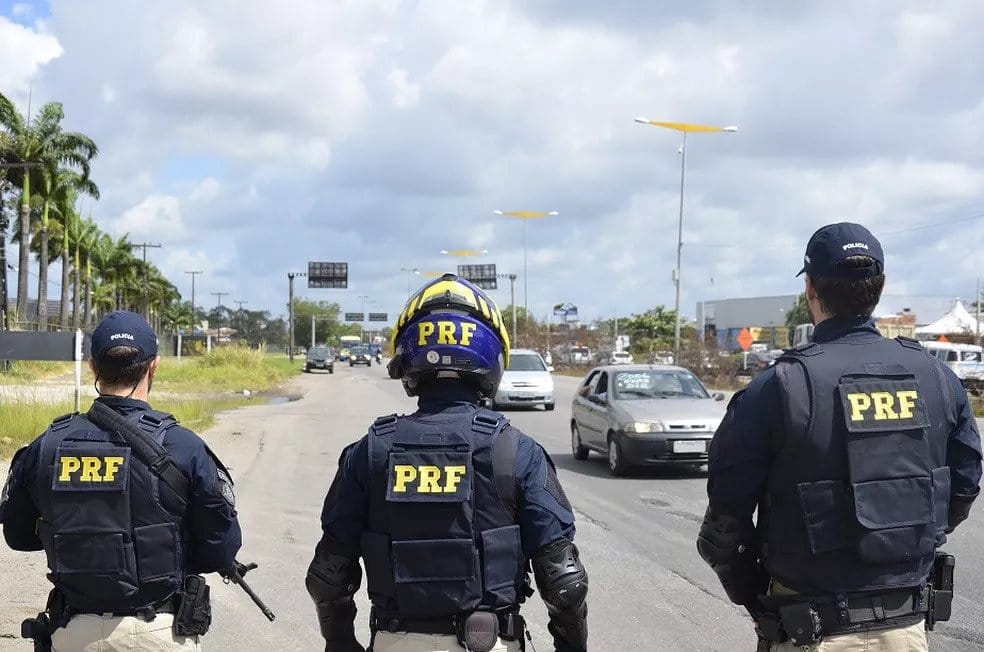 Officers from Brazil's highway police (PRF) seen from the back