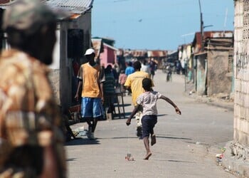A boy runs down a street in Cité Soleil, Port-au-Prince.