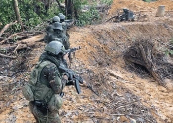 Venezuelan soldiers move across an illegal gold mining area in the southern state of Bolívar.