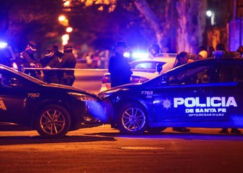 Dos carros de la policía estacionados en la escena de un crimen en Rosario, Argentina.