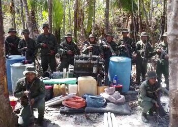Venezuelan military personnel pose for a photo after dismantling an illegal mining camp in Yapacana National Park