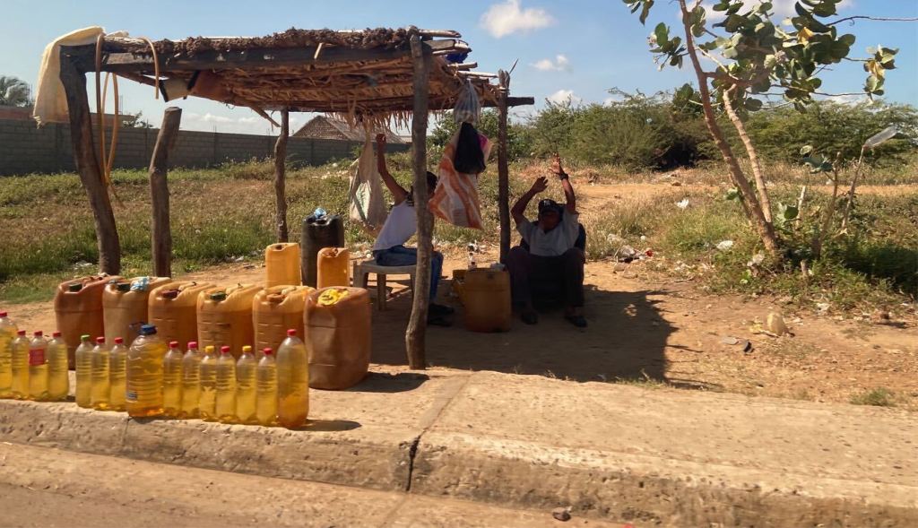 Black market gasoline salesemen hocking contraband fuel in Zulia, Venezuela