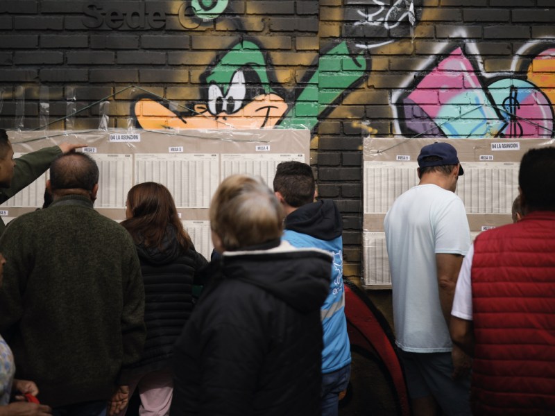 Voters look for their polling posts during local and regional elections in Bogota, Colombia, Sunday, Oct. 29, 2023.