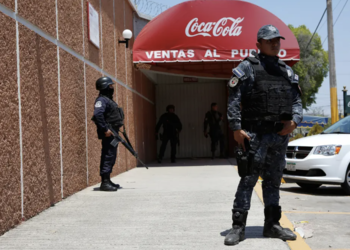 Police stand outside a factory owned by Coca Cola in Guerrero, Mexico.