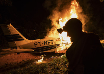 Fuerzas federales de Brasil ante avioneta en llamas, en el Amazonas. PCC provee avionetas, maquinaria y armas a mineros ilegales.