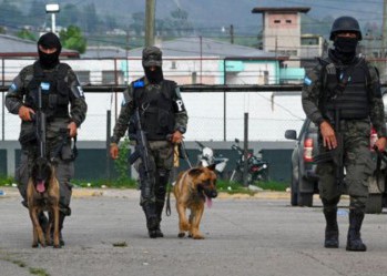 Military police patrol a prison in Honduras.