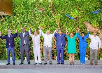 South American leaders raise their hands after signing the Belém Declaration, which provides for the preservation of the Amazon.