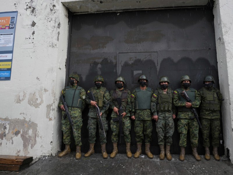 Soldiers guard the door to Inca prison in Ecuador.
