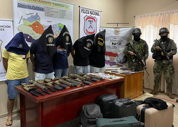 Paraguayan authorities posing for a picture with men arrested for arms trafficking in an international Interpol-led operation.