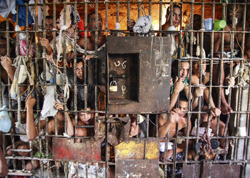Prisoners at the door of an overloaded jail cell in Brazil.