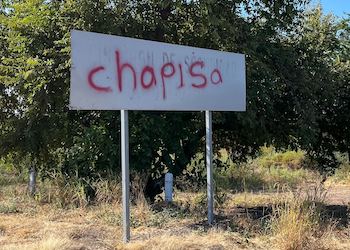 A highway sign outside Culiacán spray-painted with “Chapisa,” a reference to the Chapitos faction of the Sinaloa Cartel.